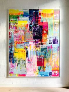 an abstract painting hangs on the wall