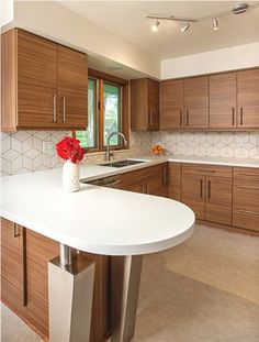 a kitchen with wooden cabinets and white counter tops