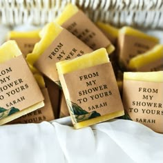 four soap bars sitting on top of each other in front of a wicker basket