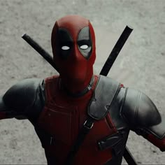 a deadpool character with two swords in his hands