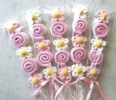 pink and white candy lollipops in cello bags with flowers on them, ready to be eaten