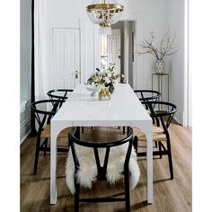 a dining room table with chairs and a chandelier