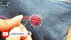 someone is stitching something on the back of a pair of jeans with red thread