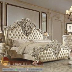 an ornate bedroom with white furniture and gold accents on the bed, dressers and mirror