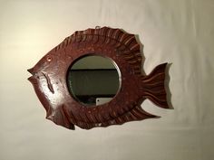 a fish shaped mirror hanging on the wall