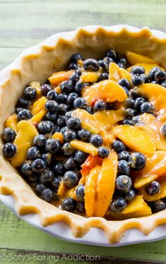 a pie with blueberries and peaches in it