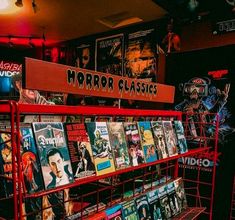 there is a red rack full of books in the store with horror classics on it