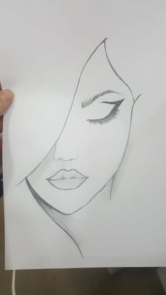 a drawing of a woman's face with her eyes closed and eyelashes drawn on paper