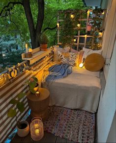 a bed sitting on top of a wooden floor next to a tree