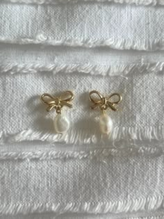 *These gold bow pearl earrings are handmade using enamel bow gold hypoallergenic earrings studs and pearls. *Cute and simple gold bow earrings that are handmade! Great for any occasion or as a cute addition to your everyday outfit. *I spend a lot of time and put lots of hard work into every single unique earring. Cheap Elegant Earrings With Pearl Charm, Cheap Everyday Jewelry With Pearl Charm, Affordable Everyday Jewelry With Pearl Charm, Affordable Cream Dangle Jewelry, Luxury Dainty Pearl Charm Earrings, Luxury Dainty Pearl Earrings With Pearl Charm, Cheap Dangle Earrings With Pearl Charm, Luxury Dainty Earrings With Pearl Charm, Gold And White Earrings