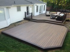 a backyard deck with seating area and patio furniture