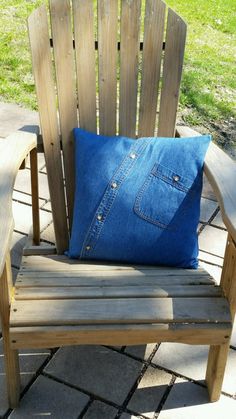 a wooden chair with a blue pillow on it