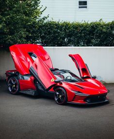 a red sports car with its doors open