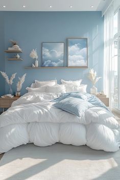 a bedroom with blue walls and white bedding