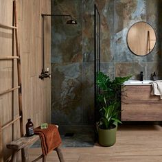 a bathroom with a sink, mirror and plants in the corner on the counter top