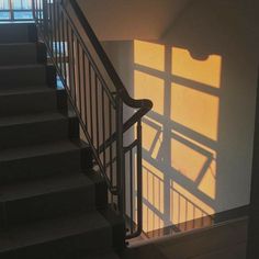 the stairs are casting shadows on the wall