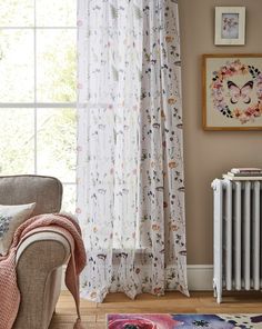 a living room filled with furniture and a white radiator next to a window