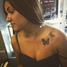 a woman with a butterfly tattoo on her chest