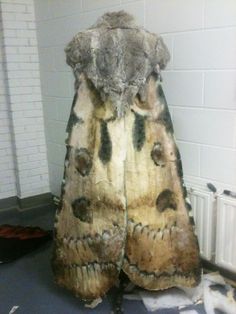 an animal fur coat sitting on top of a floor