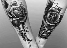 two tattoos on both arms with roses and keys in the middle one is black and white