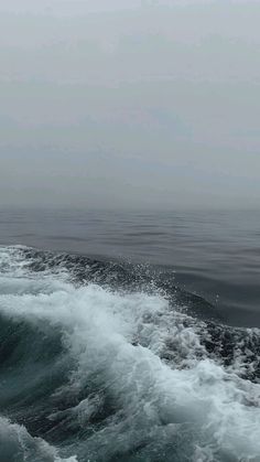 a person riding a surfboard on top of a wave in the ocean