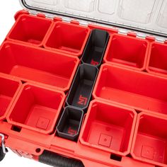 an open red tool box filled with lots of different tools in it's trays