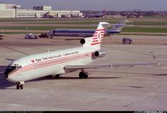 an airplane is sitting on the tarmac with other planes in the back ground behind it