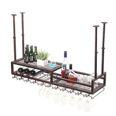 two metal racks with wine glasses and bottles on them, one is holding several empty glassware