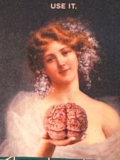 a woman holding a brain in front of her face with the caption use it