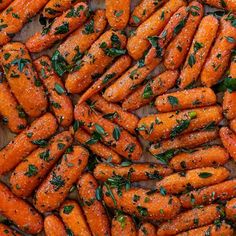 there are many carrots that have been cooked and garnished with parsley