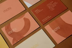 four business cards with different colors and shapes on the same card as well as an envelope