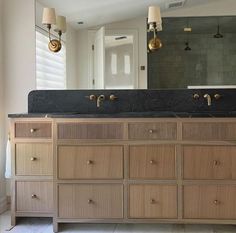 a bathroom with two sinks and a large mirror