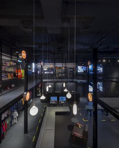 the interior of a retail store with lights hanging from the ceiling