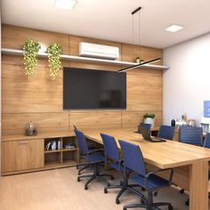 an empty conference room with blue chairs and a flat screen tv mounted on the wall