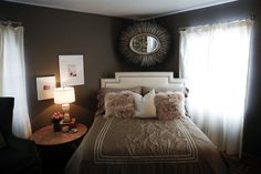 a bedroom with a large bed and two lamps on the side tables in front of it