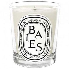 a glass candle with the words ba e s printed on it's front and side