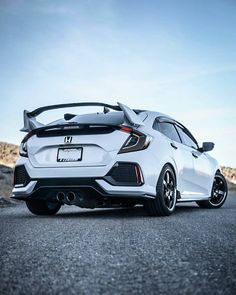 the rear end of a white honda civic hatchback