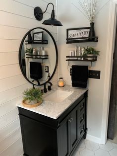 a bathroom with a sink, mirror and shelves on the wall next to each other