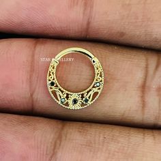 a gold ring with black stones on it