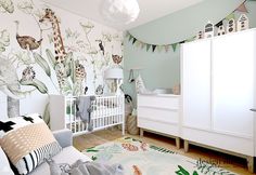 a baby's room decorated in green and white