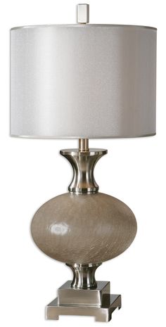 a table lamp with a white shade on it's base and a silver metal base