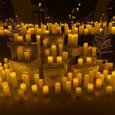 many lit candles are arranged on the floor