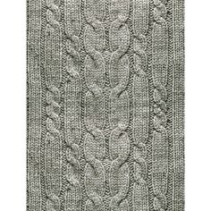 a green knitted rug with an intricate design on the front and back side,