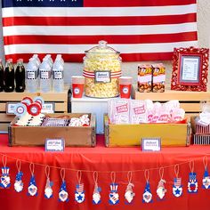 an american flag themed dessert table with popcorn