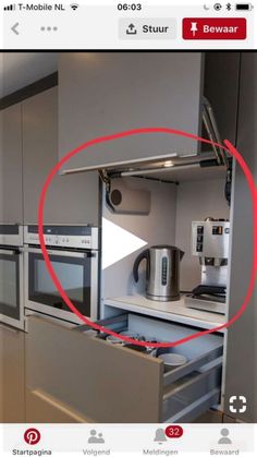 an appliance that has been placed in the middle of a kitchen with stainless steel appliances