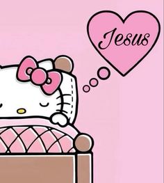 a hello kitty sitting in a bed with a heart above her head