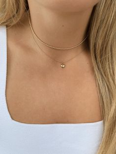 Capture the essence of timeless charm with our Mini Puffy Heart Necklace, crafted from 14k gold. This dainty necklace is 16" in length and features a petite puffy heart pendant, perfect for adding a touch of sweet elegance to any outfit. Whether worn solo or layered with other favorites, this necklace brings a subtle yet meaningful shine that effortlessly elevates your everyday style. Tennis Jewelry, Gold Heart Pendant, Gold Heart Necklace, Elegant Necklace, Puffy Heart, Elegant Necklaces