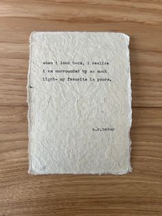 a piece of paper with an old typewriter quote on it sitting on a wooden surface