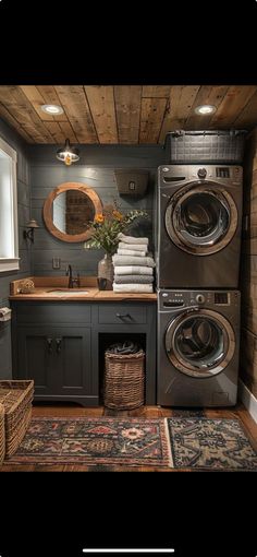 a washer and dryer in a small room with wood paneling on the walls