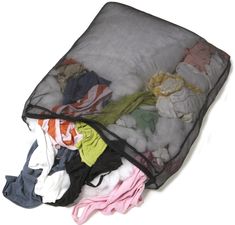 a bag filled with clothes sitting on top of a white floor